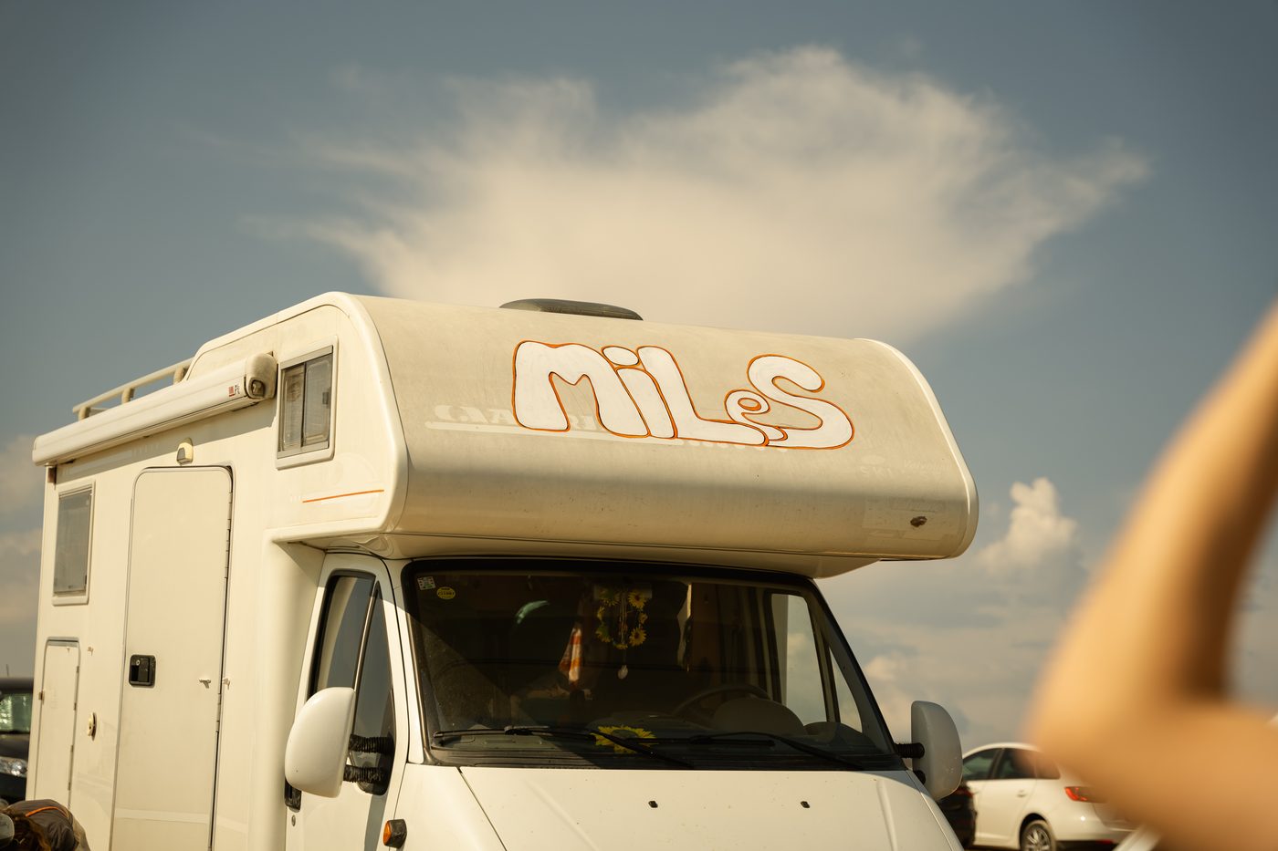 The MiLeS camper van under a wide summer sky